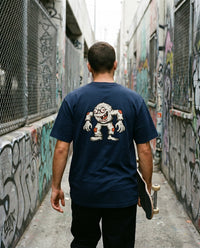Creep — Taylored Merch streetwear tee, navy, worn back view street scene