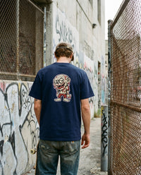 Ghoul — Taylored Merch streetwear tee, navy, worn back view street scene